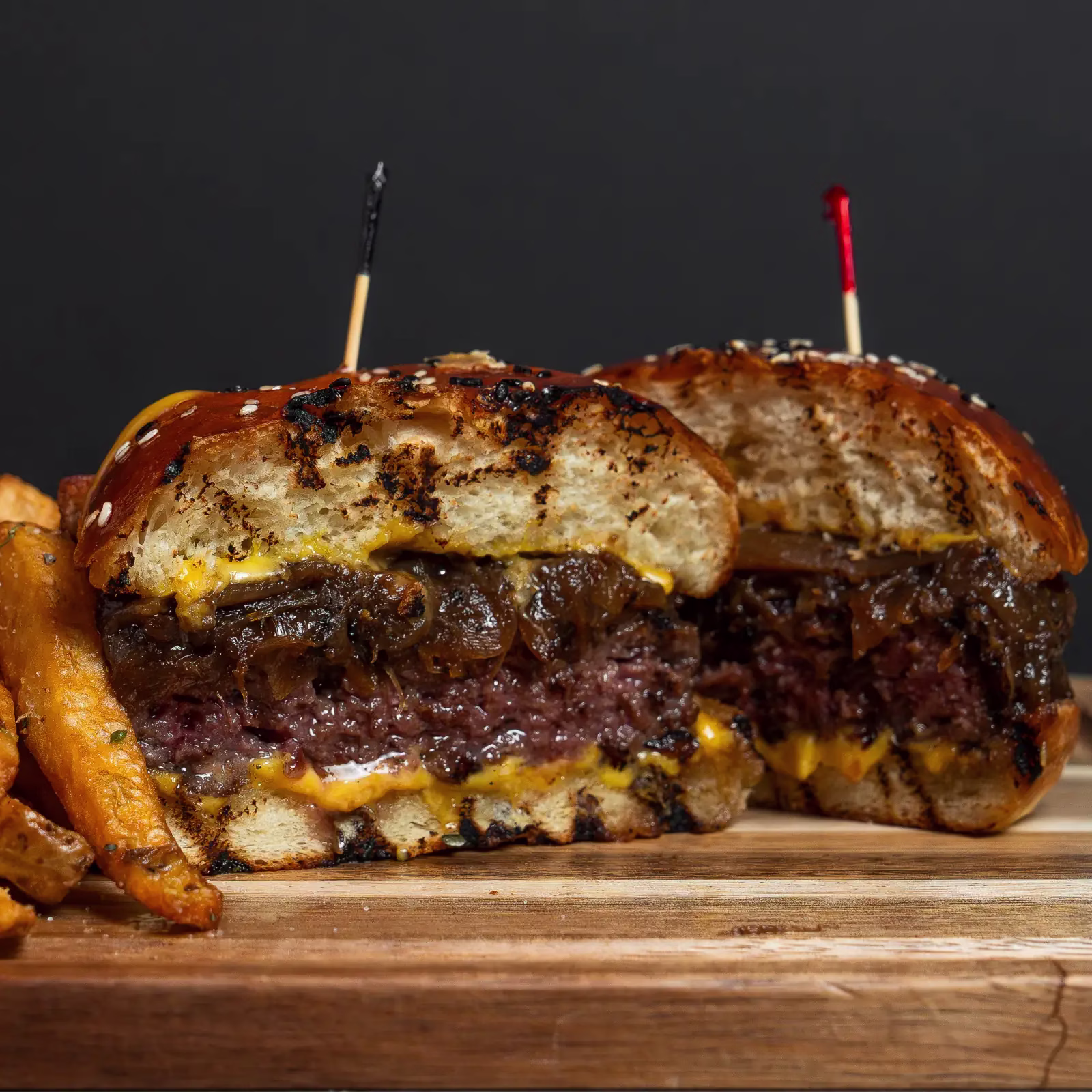 Close-up of a halal burger with melted cheese on a fresh-baked bun at FRIES B4 GUYS in Allston, Boston