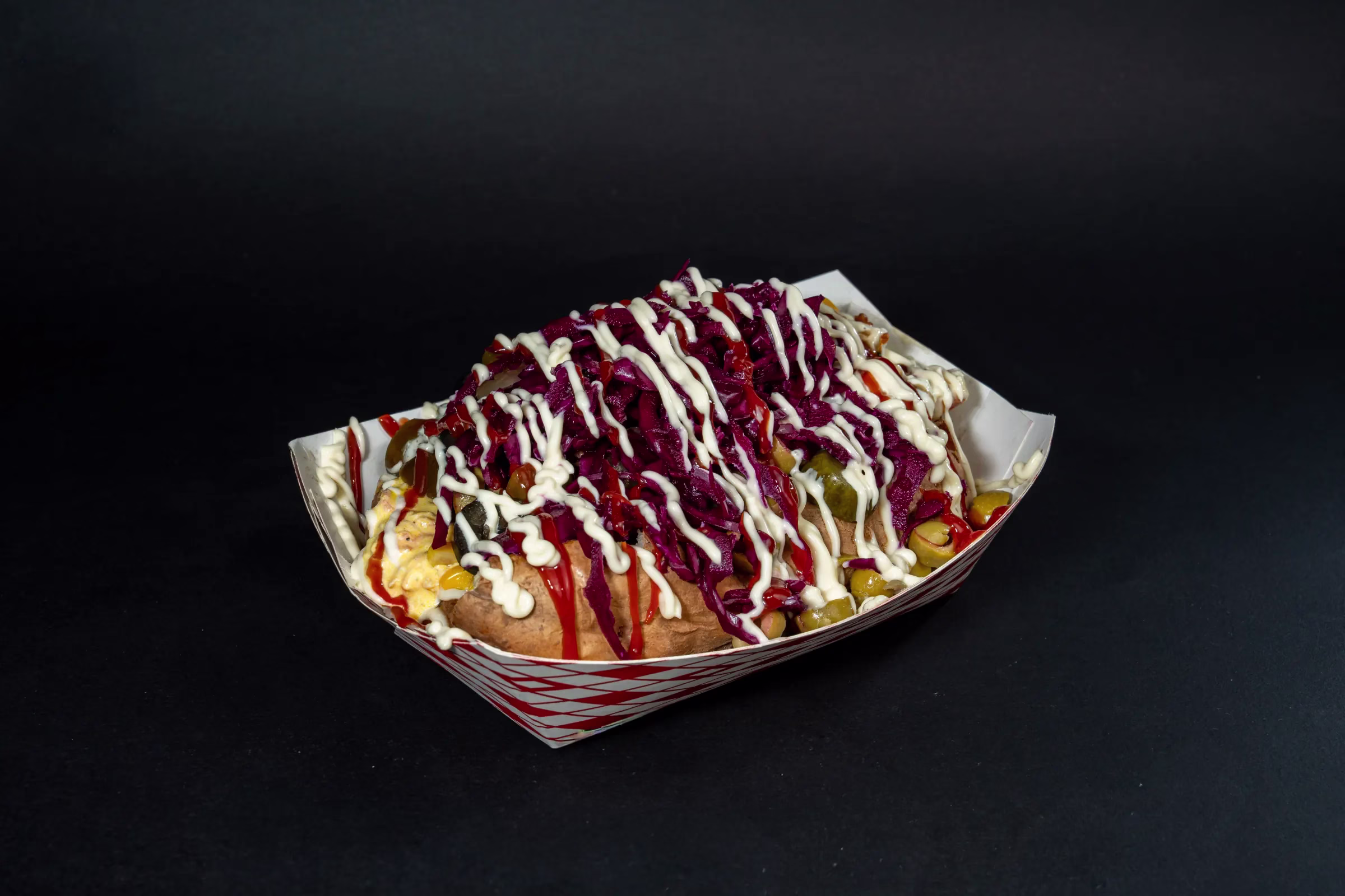 Loaded kumpir with olives, corn, and sauces at FRIES B4 GUYS in Allston, Boston